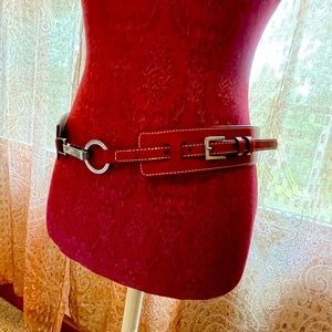 Red belt with silver buckle can be cinched to be small or medium